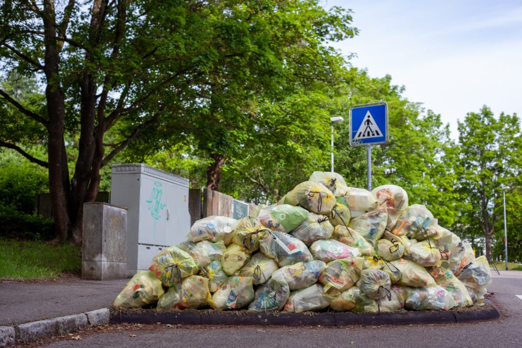 large pile of garbage bags filled with spoiled food